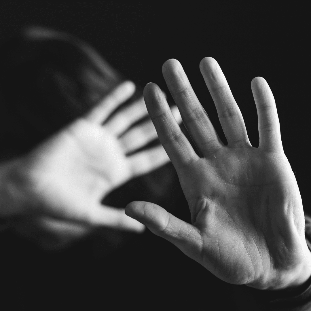 hands blocking themselves from domestic violence